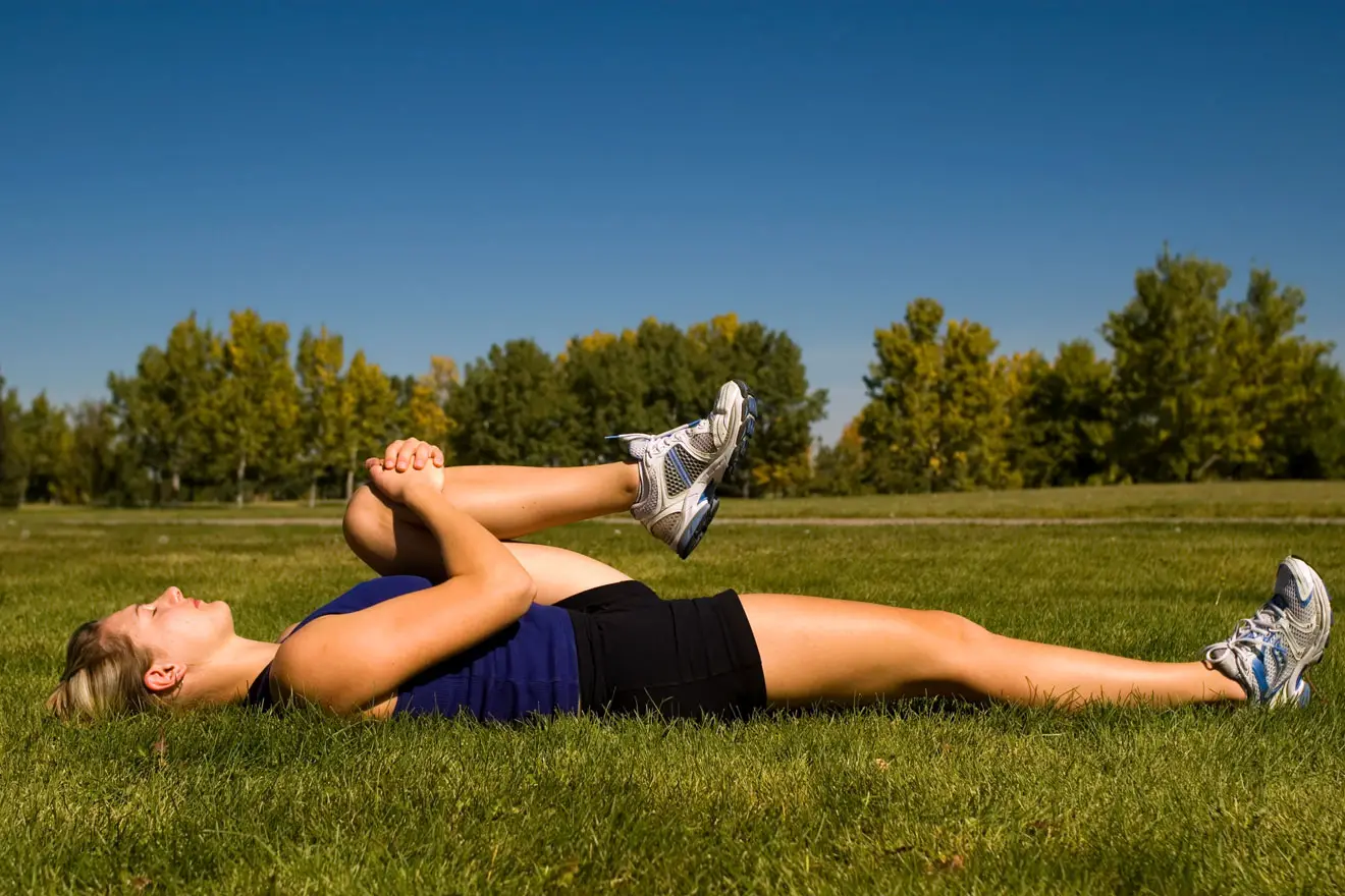 Woman stretching gluteus maximus in park