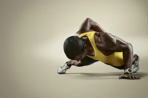 Black man doing push-ups with one arm