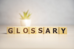 The word Glossary written in Scrabble pieces