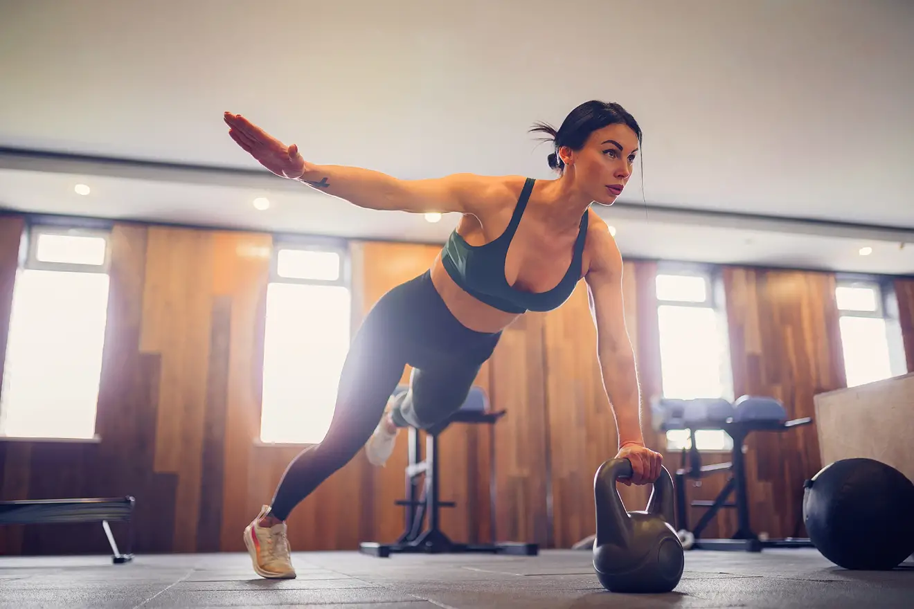 Woman with kettlebell in gym