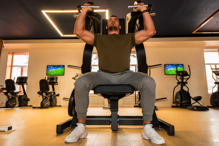 Man doing shoulder press exercise using shoulder press machine